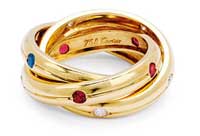 Gold and gem-set trinity band by Cartier.